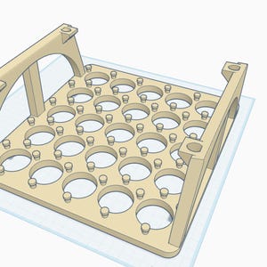 May include: A light brown, 3D-printed tray with numerous circular openings. The tray has two arched supports on each end. The design includes small pegs around the openings, suggesting a product for holding small items.