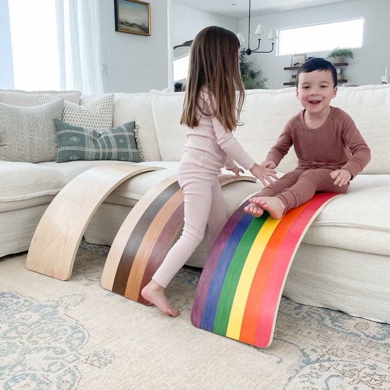 Two children playing on Bunny Hopkins wobble boards, handcrafted in the USA for active, open-ended play.