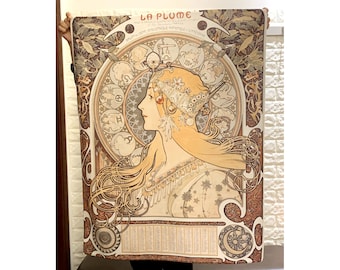 May include: A vintage poster for La Plume magazine featuring an Art Nouveau illustration of a woman with flowing hair and a crown of flowers. The poster is in shades of brown, gold, and white.
