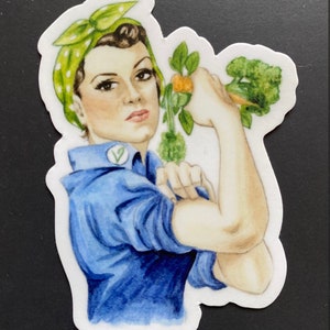 May include: A watercolour illustration of a woman with a green and white polka dot bandana, blue shirt, and a green leafy vegetable in her raised fist. The woman is depicted in the style of the iconic "We Can Do It!" Rosie the Riveter poster.