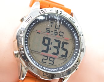 Mossimo, steel tone with orange rubber bracelet, digital wrist watch