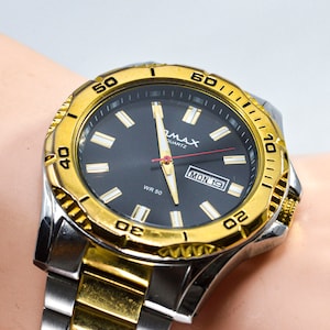 Qmax two tone. steel and gold tone , large quartz mens, wrist watch