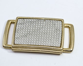 Gold and steel tone belt buckle