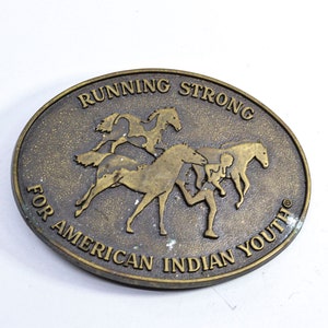 Running strong for American Indian youth , brass belt buckle