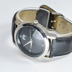 Steel tone with black dial and matching bracelet mans wrist watch