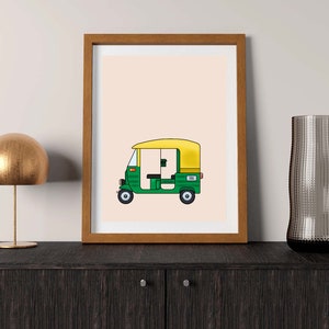 May include: A framed illustration of a green and yellow auto rickshaw, also known as a tuk-tuk, on a light peach background.