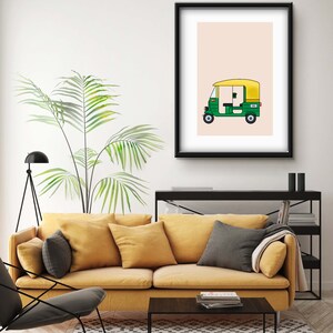 May include: A framed illustration of a green and yellow auto rickshaw, also known as a tuk-tuk, on a light pink background.