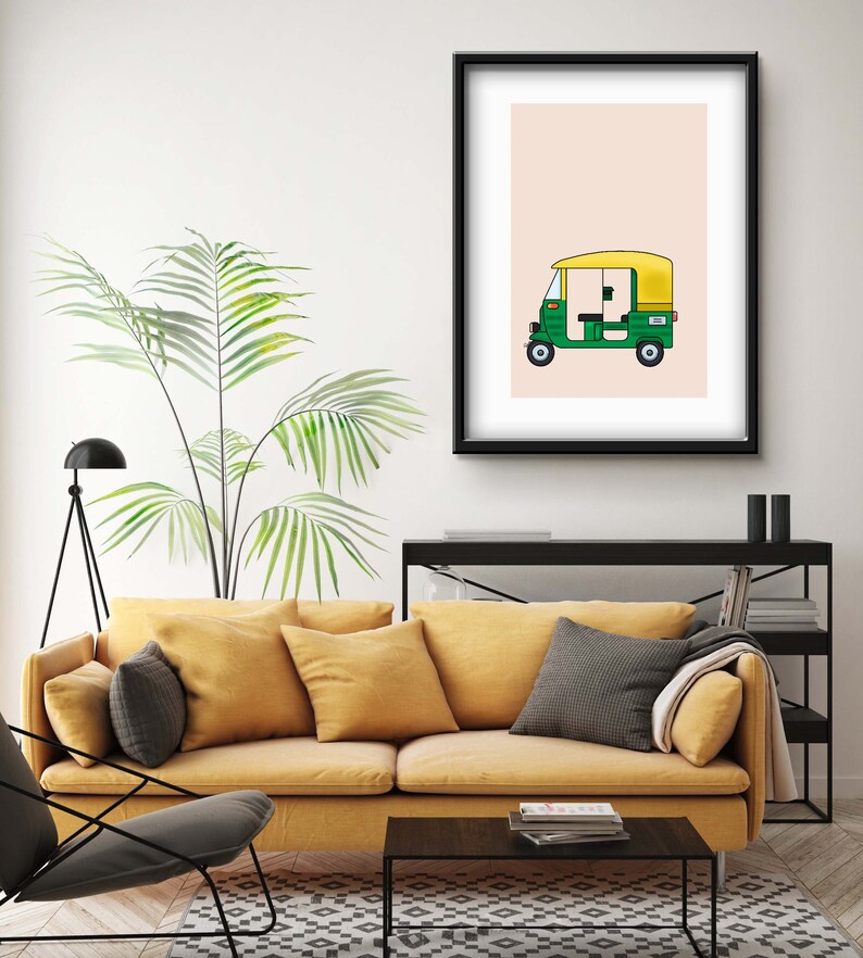 May include: A framed illustration of a green and yellow auto rickshaw, also known as a tuk-tuk, on a light pink background.