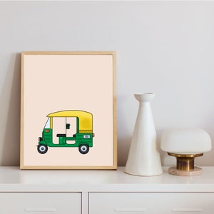 May include: A framed illustration of a green and yellow auto rickshaw, also known as a tuk-tuk, on a light peach background.