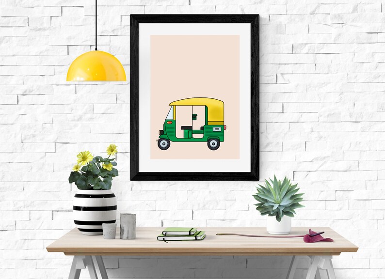 May include: A framed illustration of a green and yellow auto rickshaw, also known as a tuk-tuk, on a light peach background.