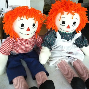 Vintage Raggedy Ann and Andy dolls with added storybooks.