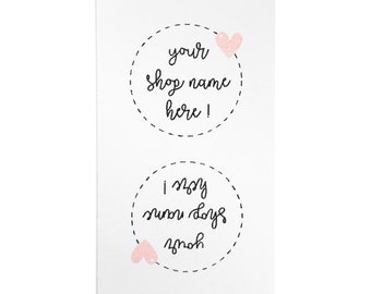 May include: Two white circle stickers with black dashed lines around the edges. The top sticker has a pink heart and the text "your shop name here!" The bottom sticker has two pink hearts and the text "I  <3  small days off".