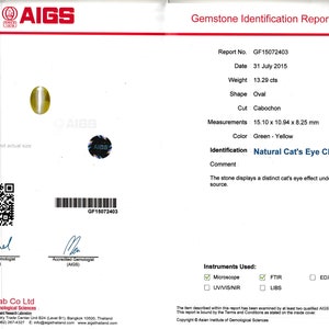 May include: A gemstone identification report from the Asian Institute of Gemological Sciences (AIGS) for a 13.29 carat oval cabochon cut green and yellow chrysoberyl. The report states the stone displays a distinct cat's eye effect under a direct light source. The report number is GF15072403 and the date is July 31, 2015.