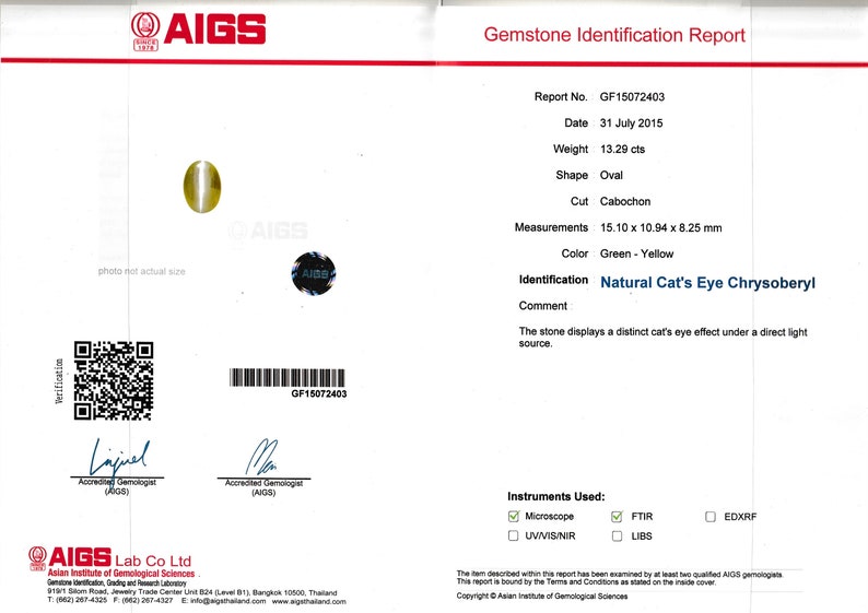 May include: A gemstone identification report from the Asian Institute of Gemological Sciences (AIGS) for a 13.29 carat oval cabochon cut green and yellow chrysoberyl. The report states the stone displays a distinct cat's eye effect under a direct light source. The report number is GF15072403 and the date is July 31, 2015.