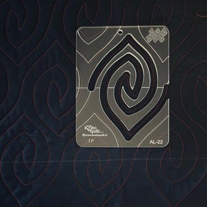 May include: A clear plastic quilting template with a swirl design. The template is 17 inches wide and has the text "I love to quilt... www.lovetoquilt.nl" and "AL-22" printed on it.
