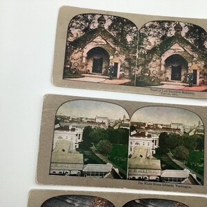 May include: Vintage stereoscopic cards featuring historical landmarks. One card depicts the Tomb of President McKinley in Canton, Ohio. Another shows the White House Grounds in Washington, D.C. The cards have a sepia tone.