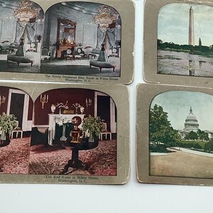 May include: A collection of vintage stereoscopic cards featuring historical scenes. The cards depict interior views of rooms, the Washington Monument, and the U.S. Capitol building. The cards have a sepia tone and are mounted on cardboard.
