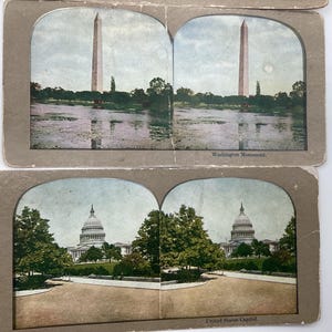 May include: Vintage stereoscopic cards featuring the Washington Monument and the United States Capitol. The cards have a sepia tone and depict the landmarks with trees and water. The text "Washington Monument" and "United States Capitol" are visible.