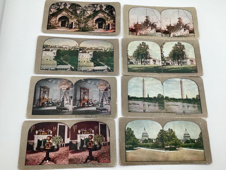May include: A collection of vintage stereoscopic cards featuring various scenes. The cards depict buildings, monuments, and interiors, including the White House, Washington Monument, and U.S. Capitol. The cards are in shades of brown, green, and blue.