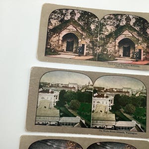 May include: A collection of vintage stereoview cards featuring historical landmarks. The cards depict the Tomb of Late President McKinley in Canton, Ohio, and the White House Grounds in Washington, D.C. The cards have a sepia tone.