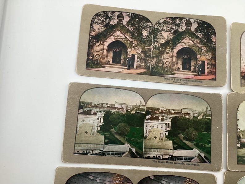 May include: A collection of vintage stereoview cards featuring historical landmarks. The cards depict the Tomb of Late President McKinley in Canton, Ohio, and the White House Grounds in Washington, D.C. The cards have a sepia tone.