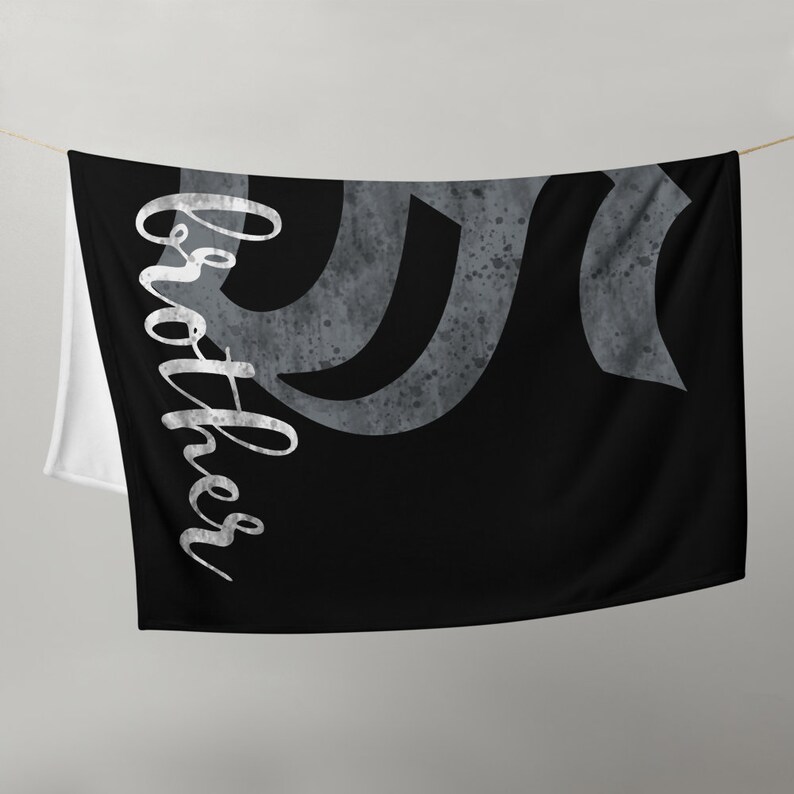 May include: Black and white beach towel with a gray abstract design and the word "Brother" written in white cursive script.