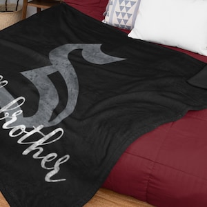 May include: Black fleece throw blanket with a gray musical note design and the text "Hello Brother" in white.