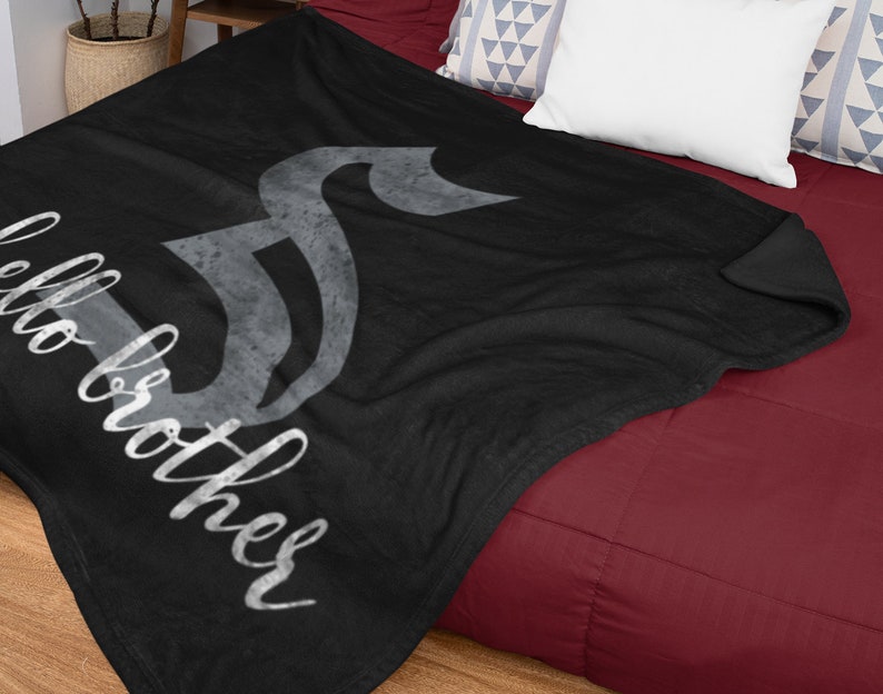 May include: Black fleece throw blanket with a gray musical note design and the text "Hello Brother" in white.