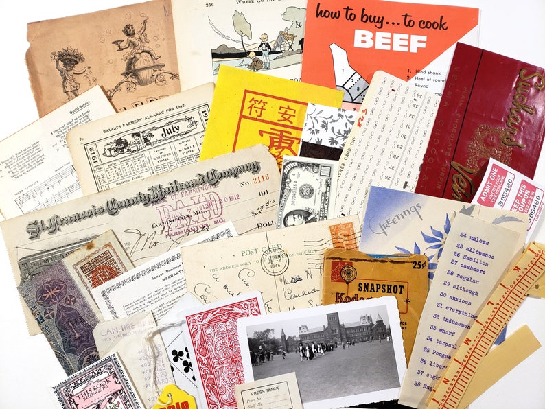 May include: A collection of vintage ephemera, including receipts, postcards, playing cards, and printed materials. Notable items include a "how to buy... to cook BEEF" guide, a dollar bill, and a "Greetings" postcard. The items are arranged on a white background.