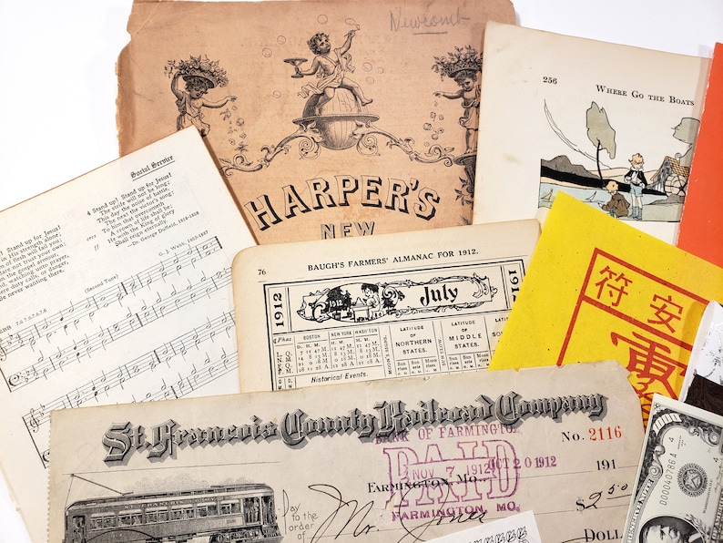 May include: A collection of vintage ephemera, including sheet music, a Harper's New magazine cover, a Baugh's Farmers' Almanac for 1912, and a St. Francis County Railroad Company check. The items are aged with a sepia tone.