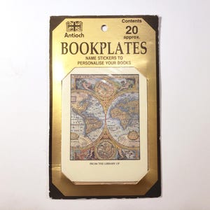 May include: A package of bookplates with a vintage map design. The bookplates are labeled "BOOKPLATES" and "NAME STICKERS TO PERSONALISE YOUR BOOKS". The package has a gold border and the text "FROM THE LIBRARY OF".