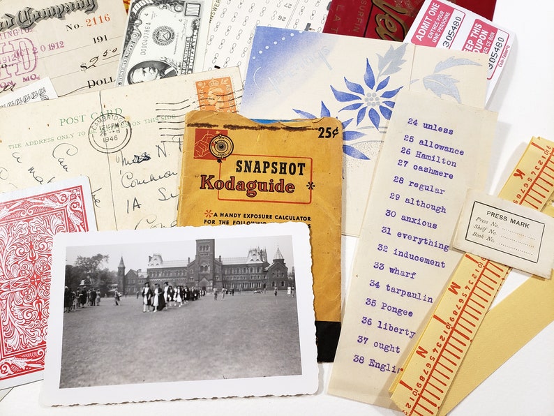 May include: A collection of vintage ephemera, including a postcard, a check, a Kodak exposure guide, and a black and white photograph of a building with people. Also included are tickets, a playing card, and a list of words.
