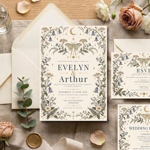 May include: A cream-colored wedding invitation suite featuring a central moth illustration, celestial moon and star motifs, and botanical borders of bluebells and ferns. The text includes the names Evelyn and Arthur, date, and location details.