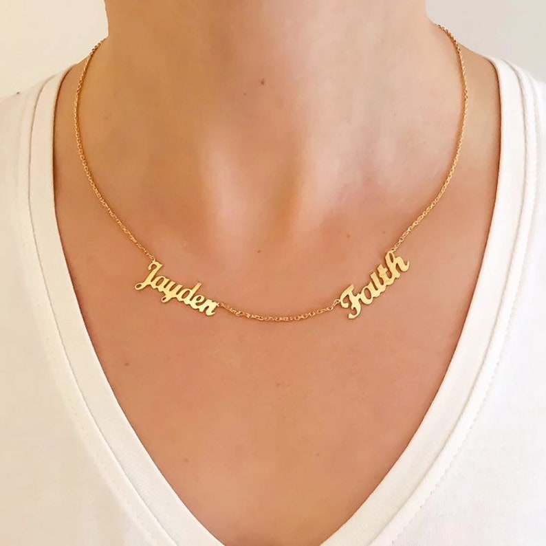 May include: Gold necklace with two names, "Jayden" and "Faith", spelled out in cursive.