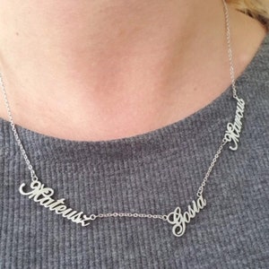 May include: Silver necklace with three names, "Matheus", "Sofia", and "Ramos", spelled out in cursive.