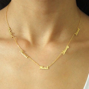 May include: A gold chain necklace with five personalized name tags. The names on the tags are "Hessa", "Hend", "Shauqi", "Saud", and "Wheedat".