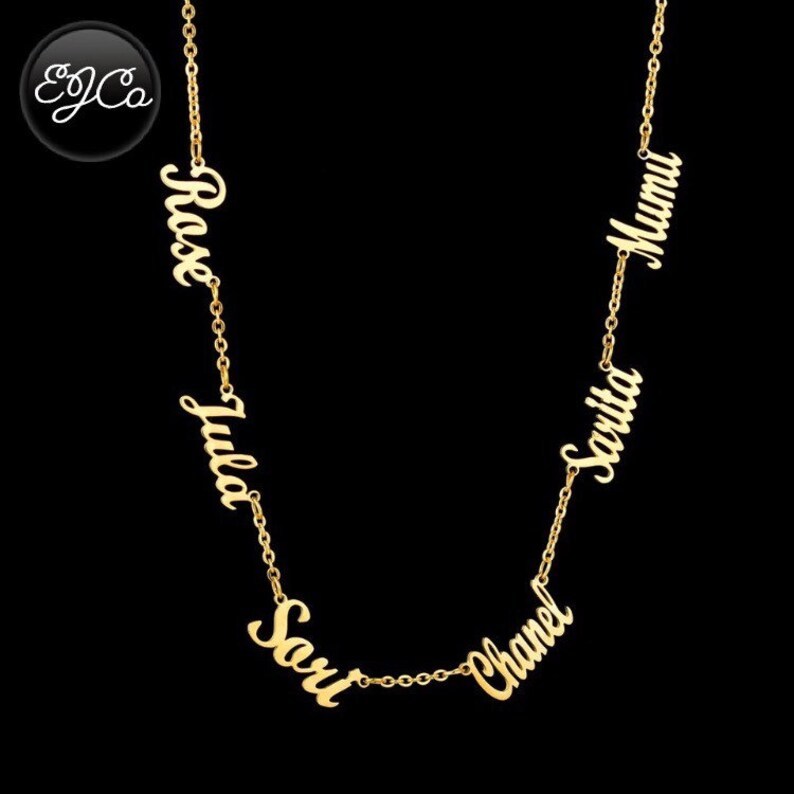 May include: Gold necklace with five names, "Rose", "Julia", "Sari", "Chanel", and "Mumu", hanging from the chain.