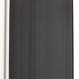 May include: A blank black magnetic surface with a white frame. The surface is designed for writing or displaying notes.