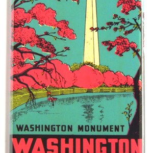 May include: A vintage-style postcard featuring a view of the Washington Monument in Washington, D.C. The monument is white and tall, with a blue sky and pink cherry blossoms in the background. The text on the postcard reads "Washington Monument, Washington, District of Columbia."