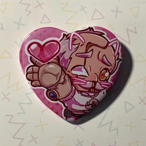 May include: A pink heart-shaped button with a cartoon character holding a pink heart. The character has white fur, pink ears, and a pink nose. The character is wearing a white and pink outfit.