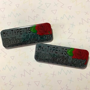 May include: Two gray and black rectangular buttons with a red rose graphic and the text "My Type Is: Fictional Women" and "My Type Is: Fictional Men".
