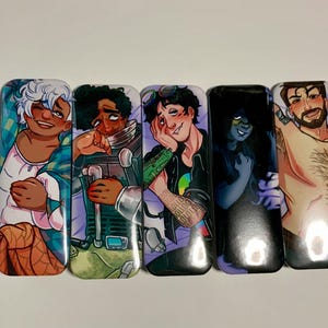 May include: Five rectangular phone grip accessories with colorful illustrations of various characters. The characters have diverse skin tones and wear a variety of clothing. The backgrounds are a mix of colors, including purple, blue, and green.
