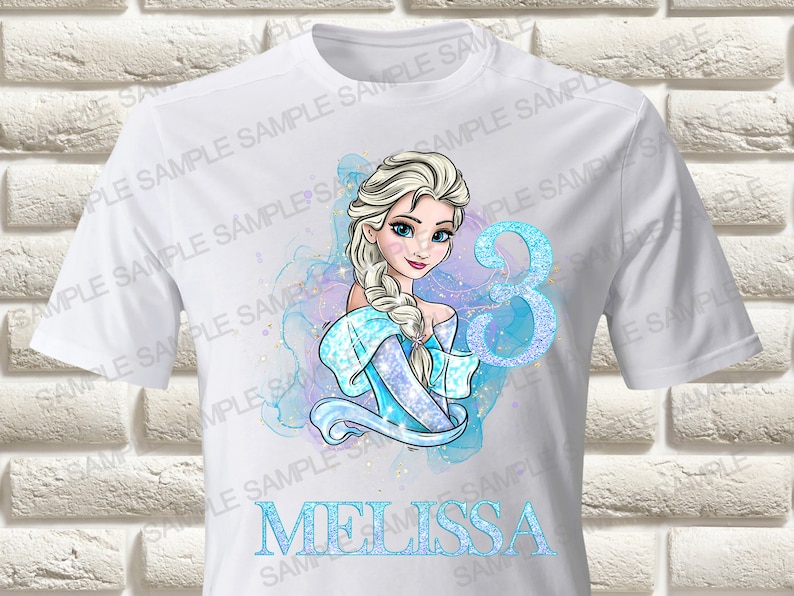 May include: White t-shirt with a blue and white illustration of Elsa from Frozen. The illustration includes a sparkly blue number 3 and the name "Melissa".