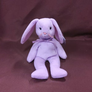 TY Beanie Baby &quot;Floppity&quot; the Lilac Rabbit. New, never played with. Stored smoke free. All tags in place. Vintage - 1996 with PVC Pellets .