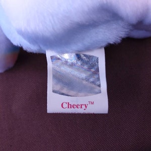 May include: White tag with a silver holographic sticker and the text "Cheery&trade;" in pink lettering. The tag also says "Handmade in China".