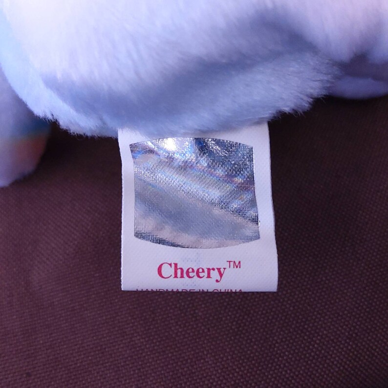May include: White tag with a silver holographic sticker and the text "Cheery&trade;" in pink lettering. The tag also says "Handmade in China".