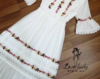 white dress with blue embroidery
