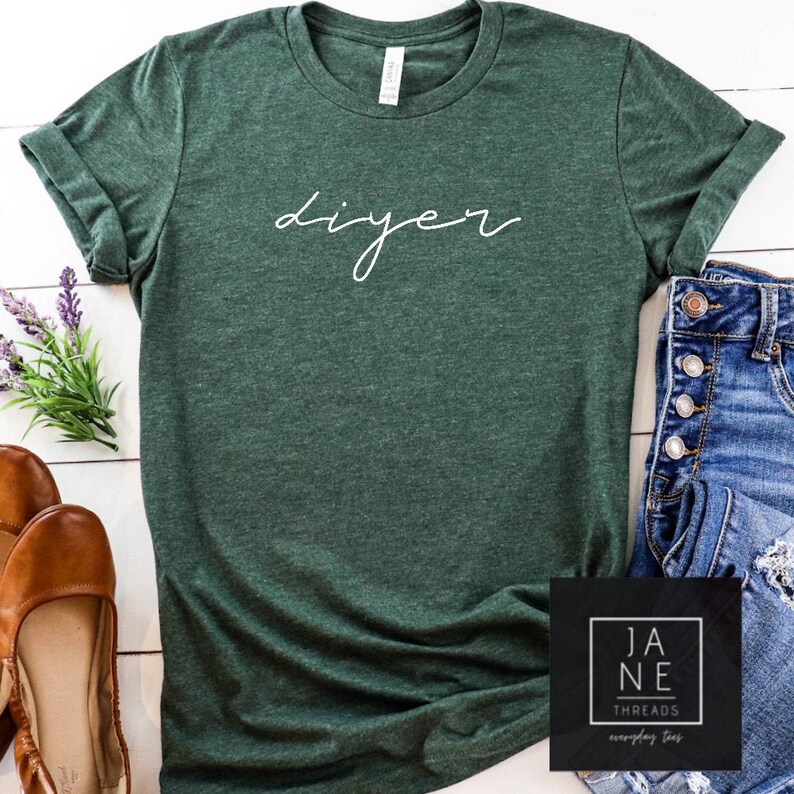May include: A dark green t-shirt with the word "DIYer" written in white cursive lettering.