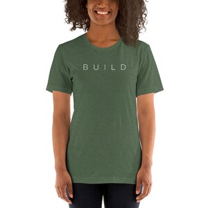 May include: A green t-shirt with the word "BUILD" printed in white on the front.
