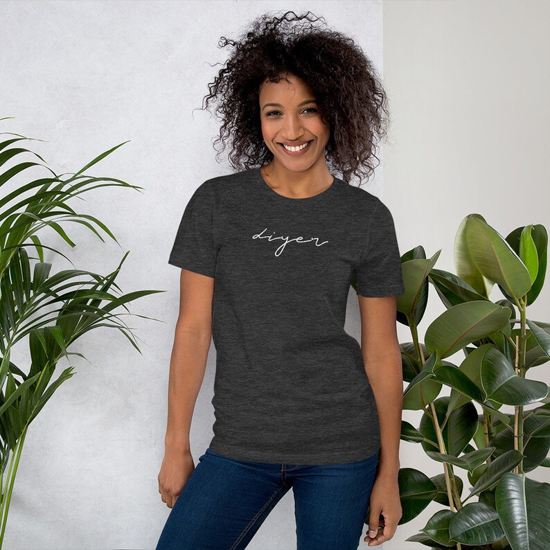 May include: A dark heather grey t-shirt with the word "DIYer" written in white cursive script.